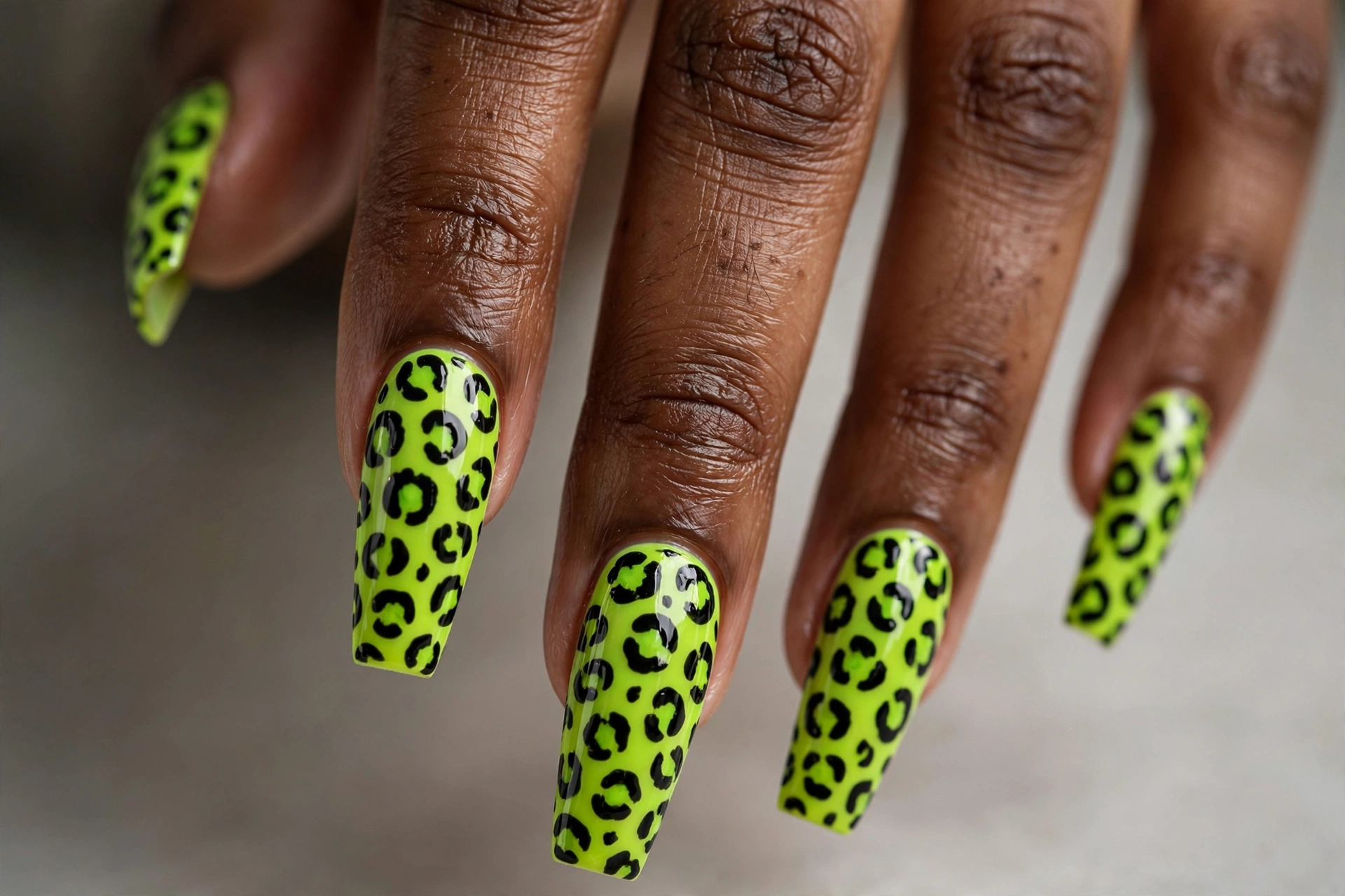 Neon lime green leopard print with black spots on long coffin nails
