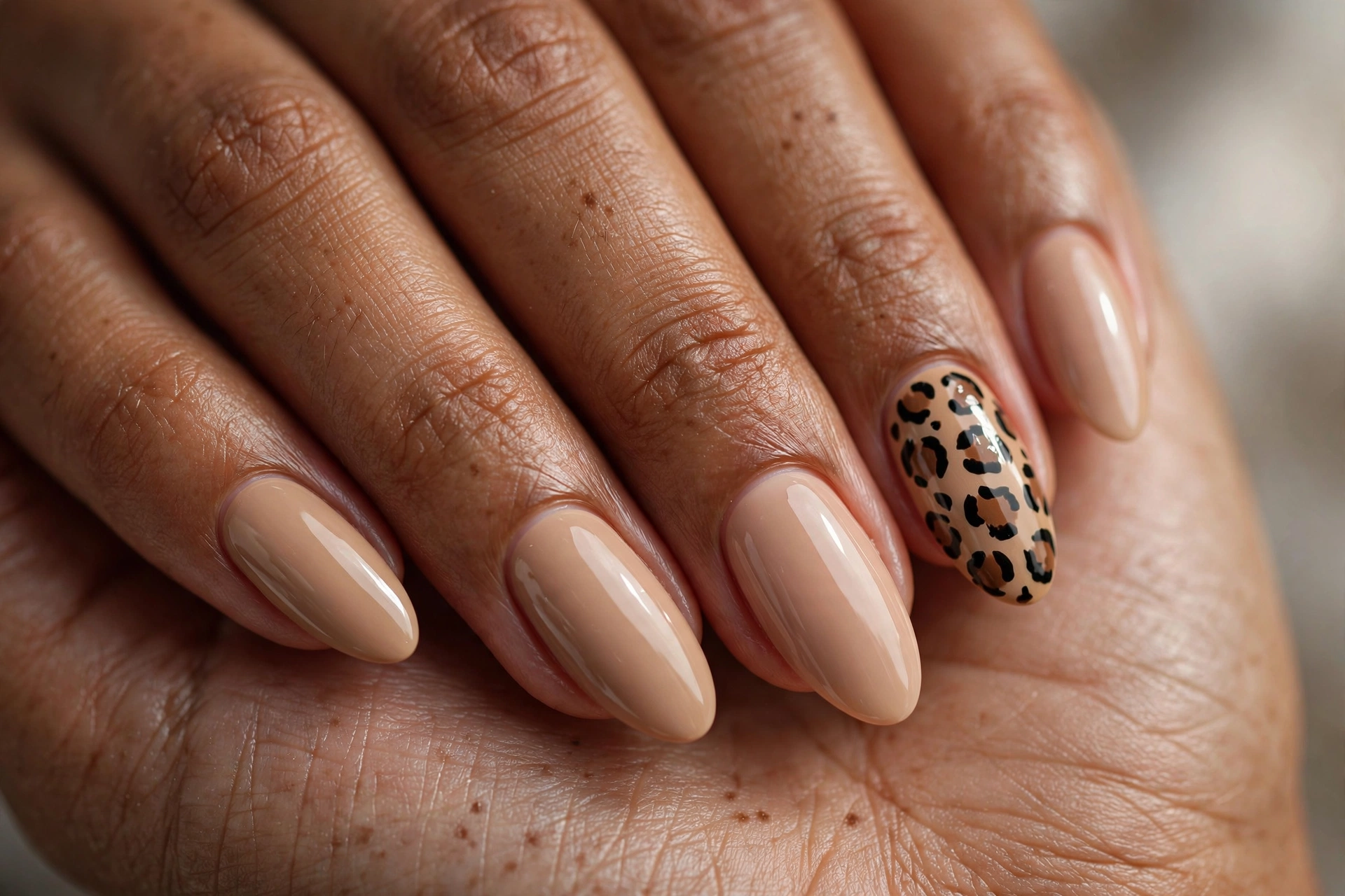 Single leopard print accent nail among glossy nude beige nails