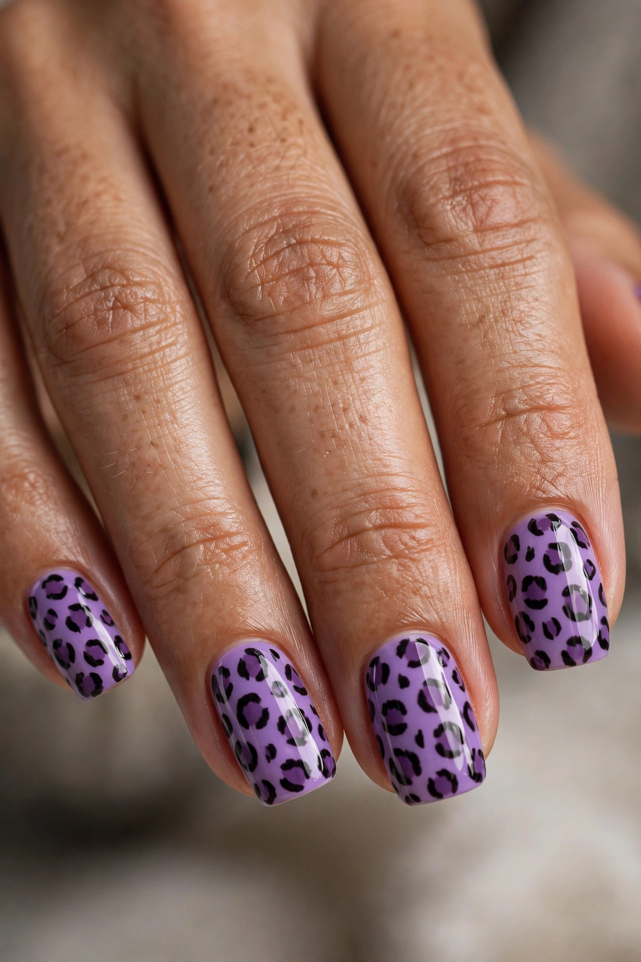 Lavender purple leopard print with dark plum spots on squoval nails