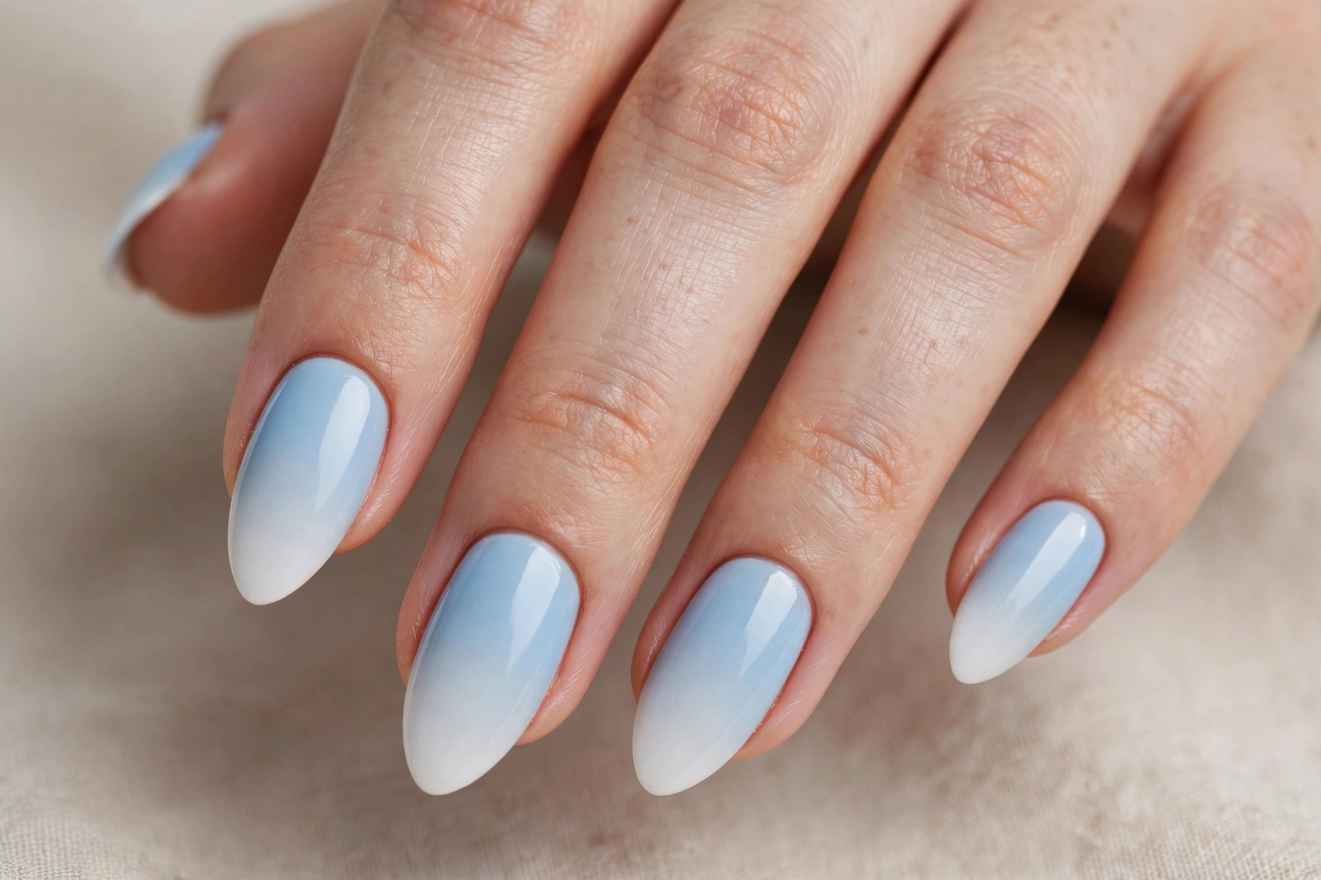 Baby blue to white ombre gradient nails on almond nails