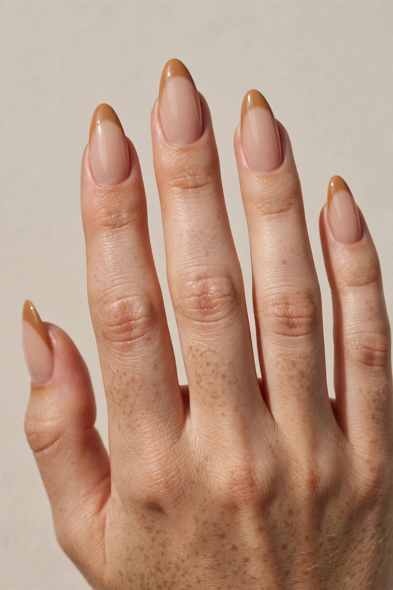 Caramel latte French tips on nude base, long almond shaped nails