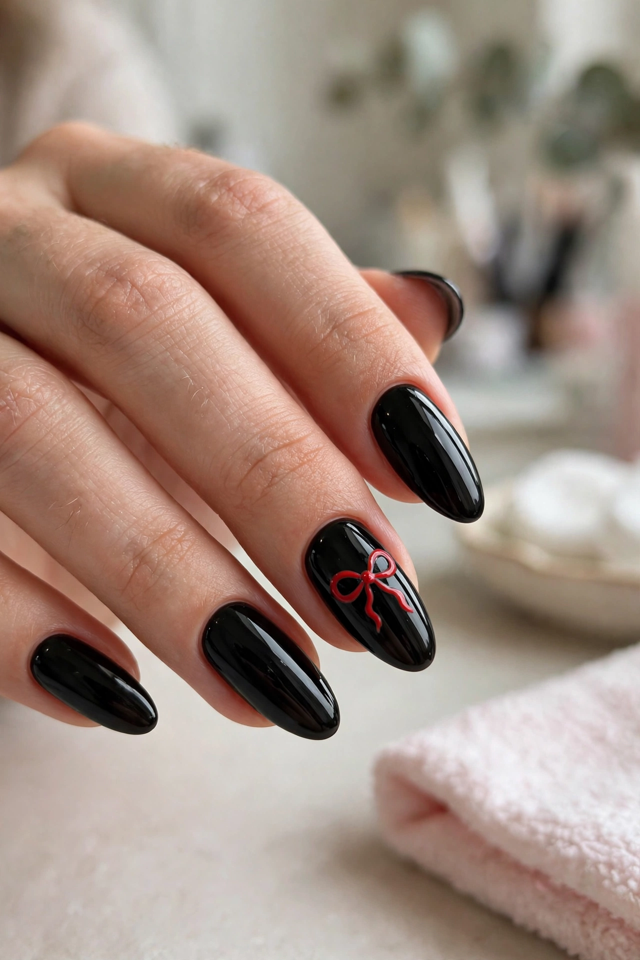 Black nails with red bow accent nail art
