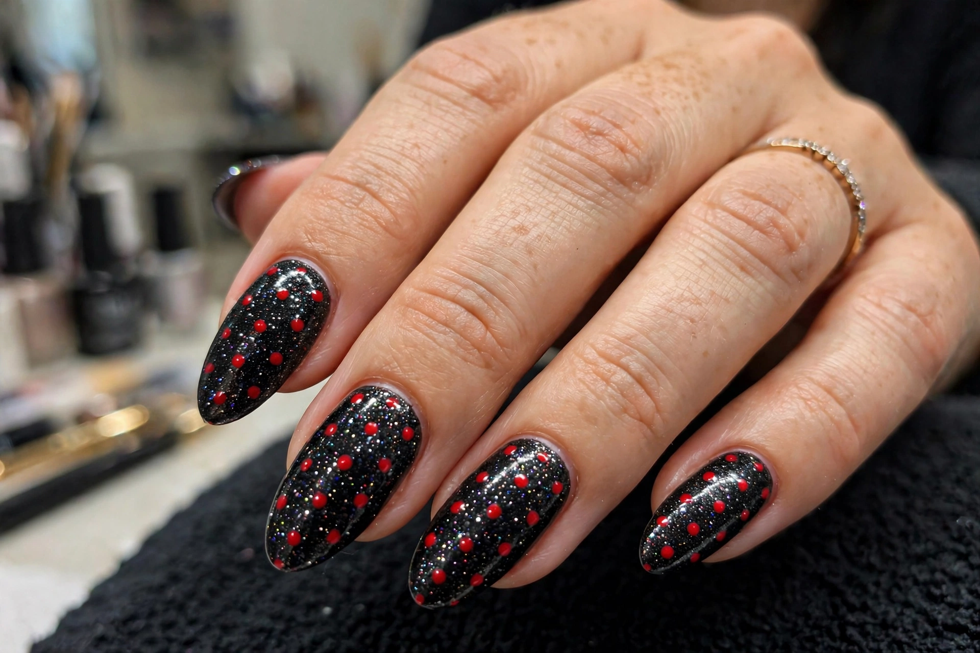 Black glitter nails with red polka dots