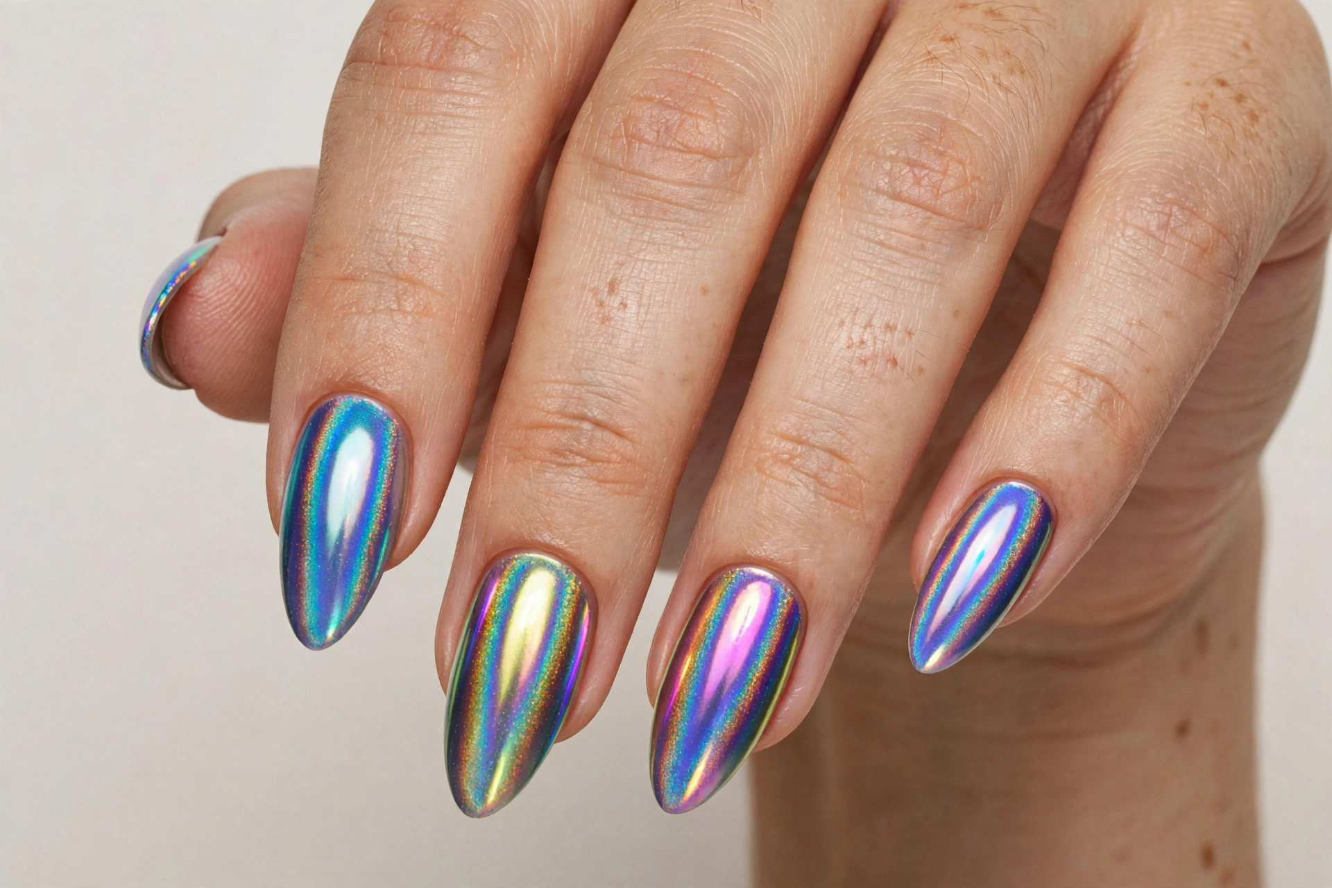Holographic chrome music festival nails with rainbow mirror shine