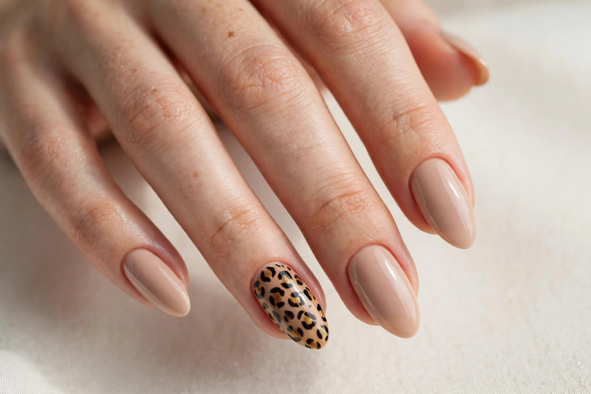 Leopard print accent nail art manicure on almond shaped nails