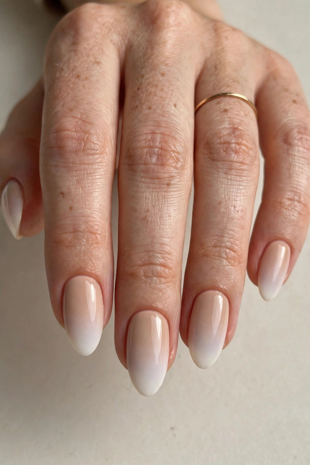 Beige to white ombre nail design 2025 on almond nails
