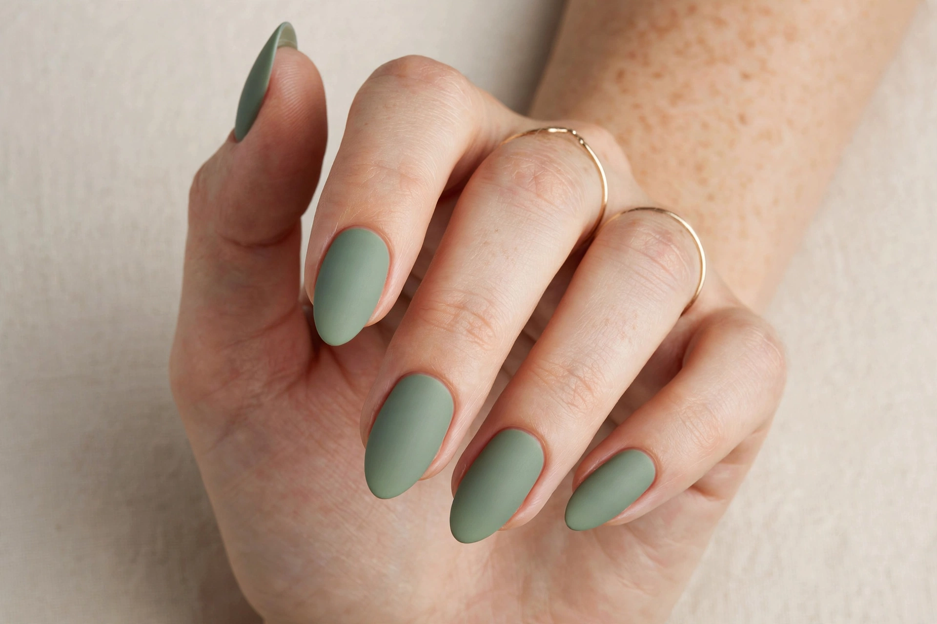 Sage green matte manicure on almond nails