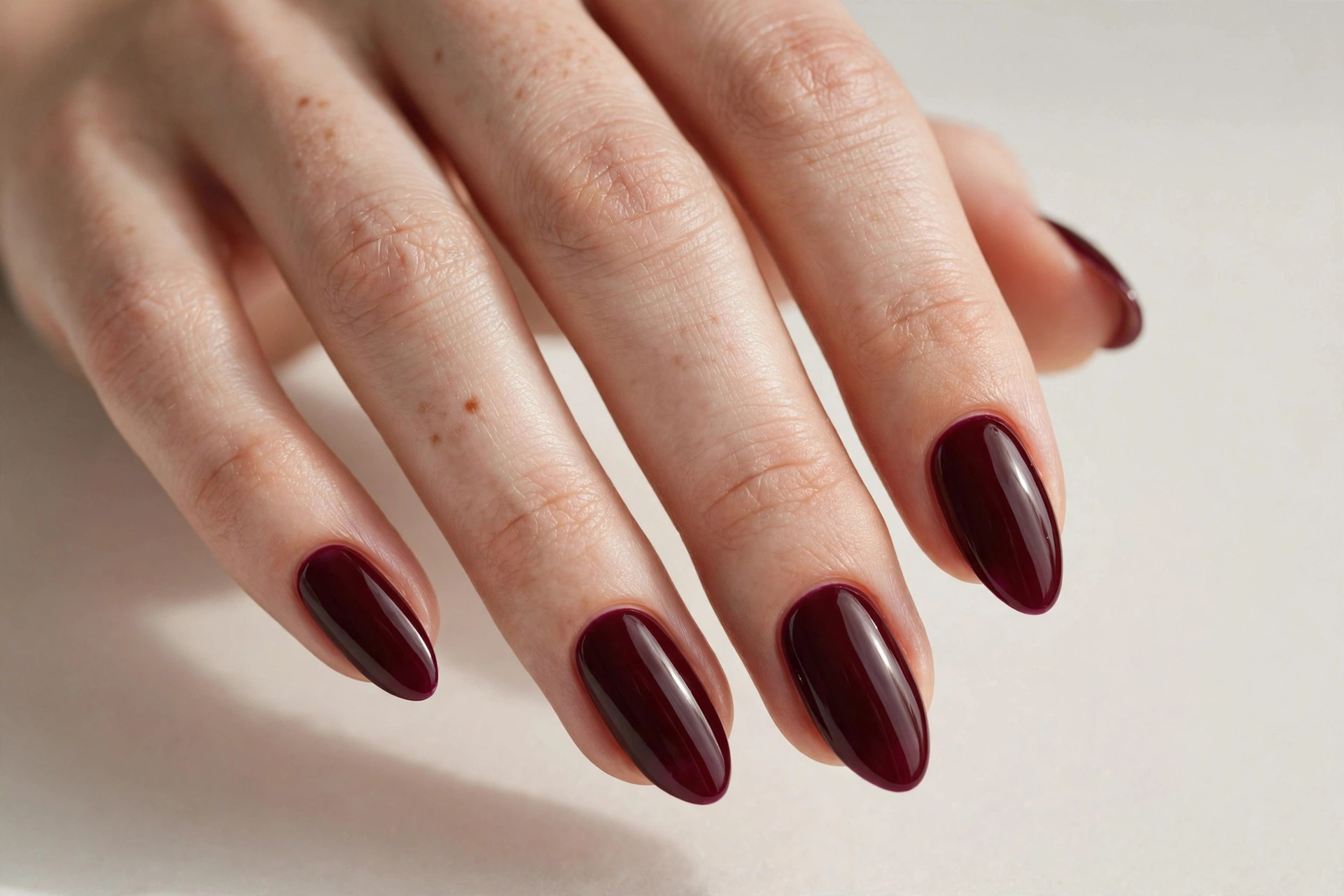 Deep burgundy wine nail varnish manicure on almond shaped nails