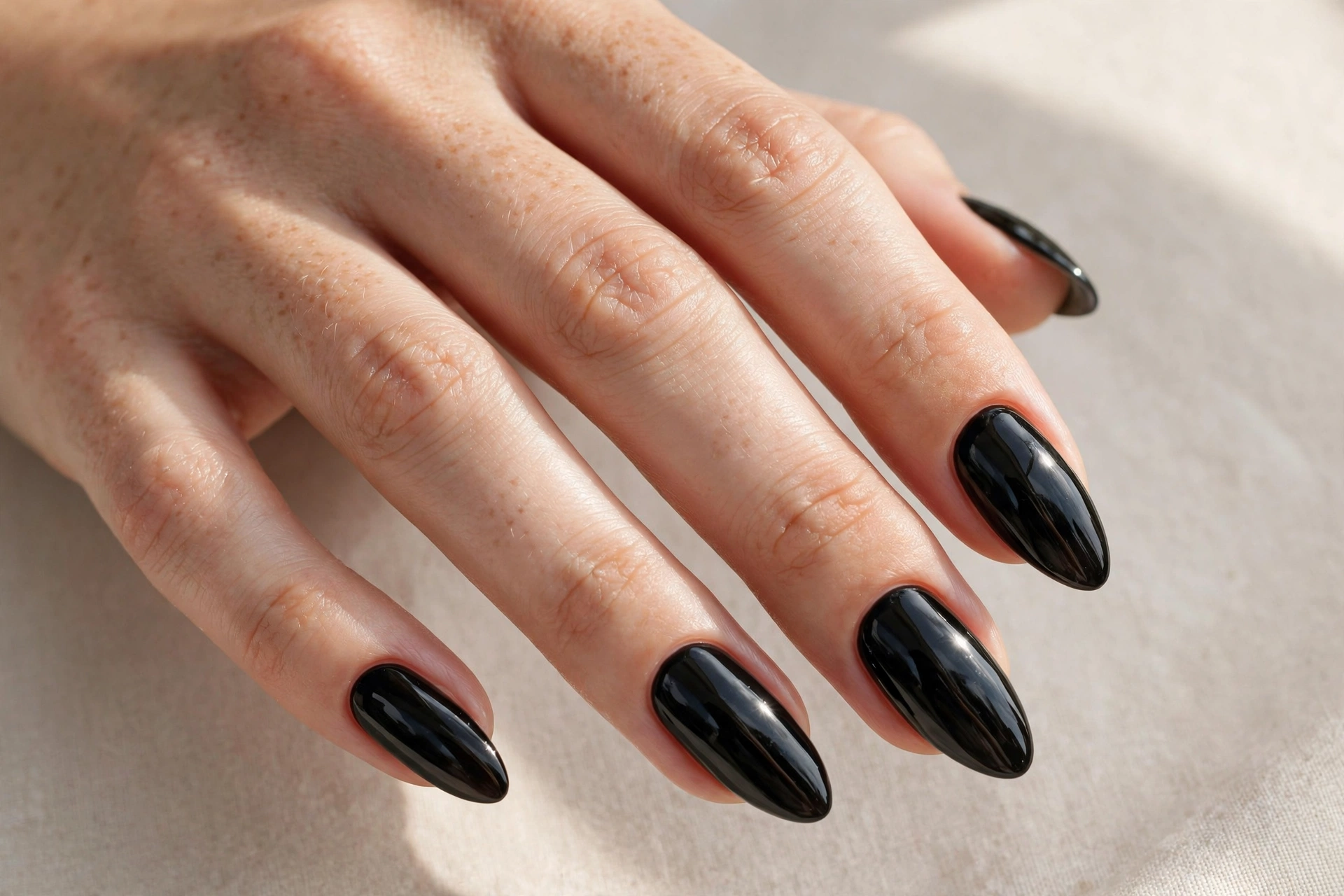 Black patent leather nail varnish manicure on almond shaped nails