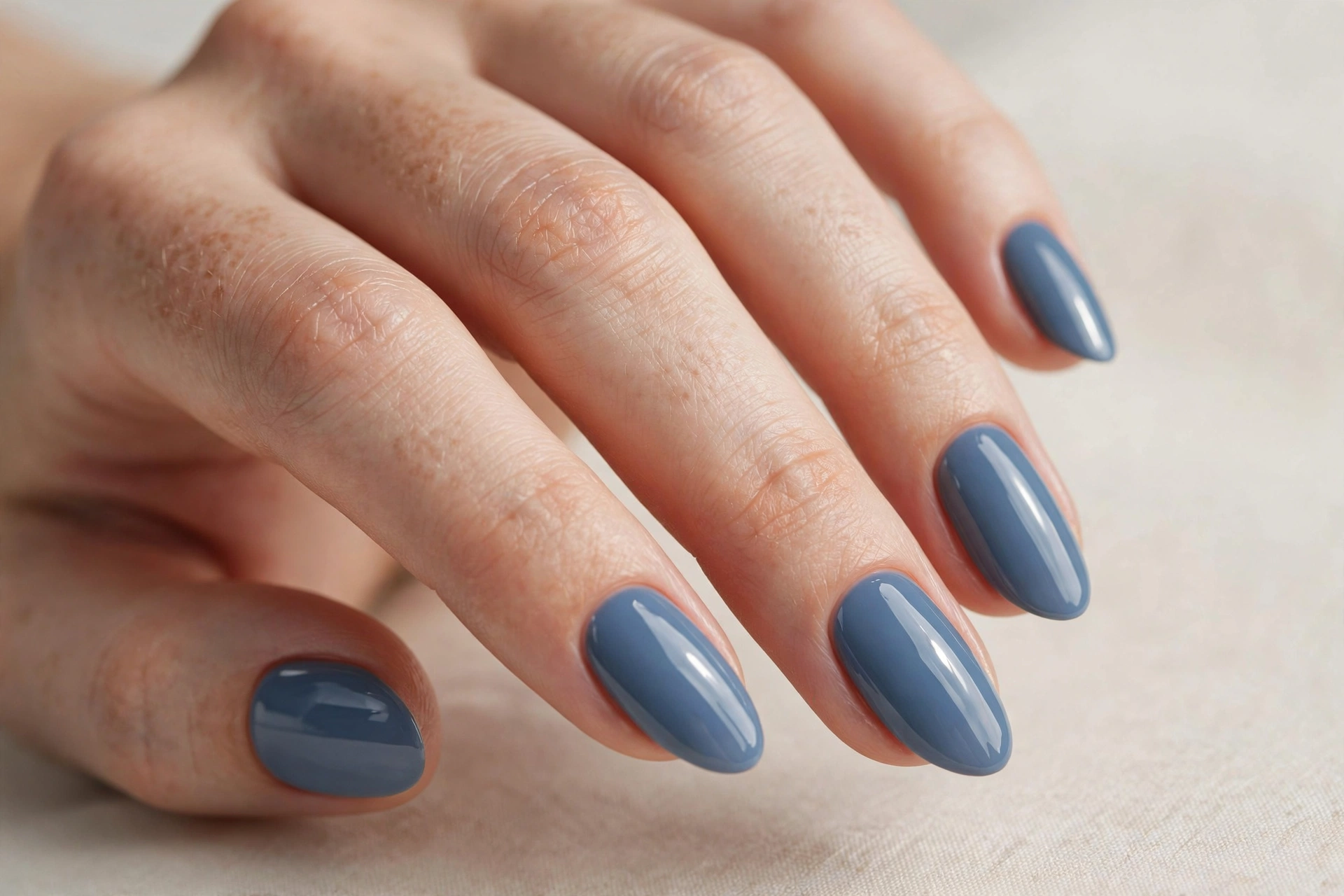 Dusty blue nail varnish manicure on almond shaped nails