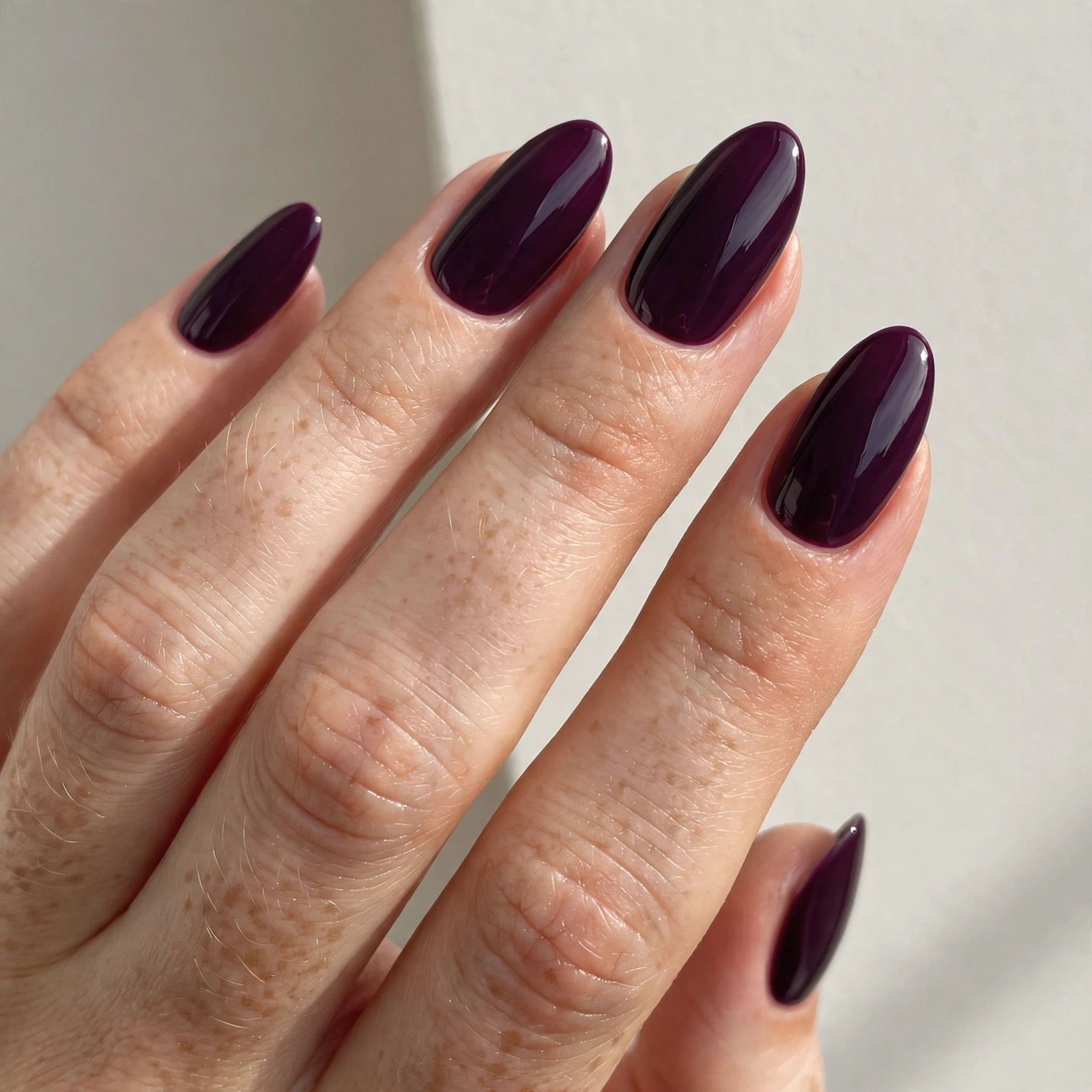 Deep plum nail varnish manicure on almond shaped nails