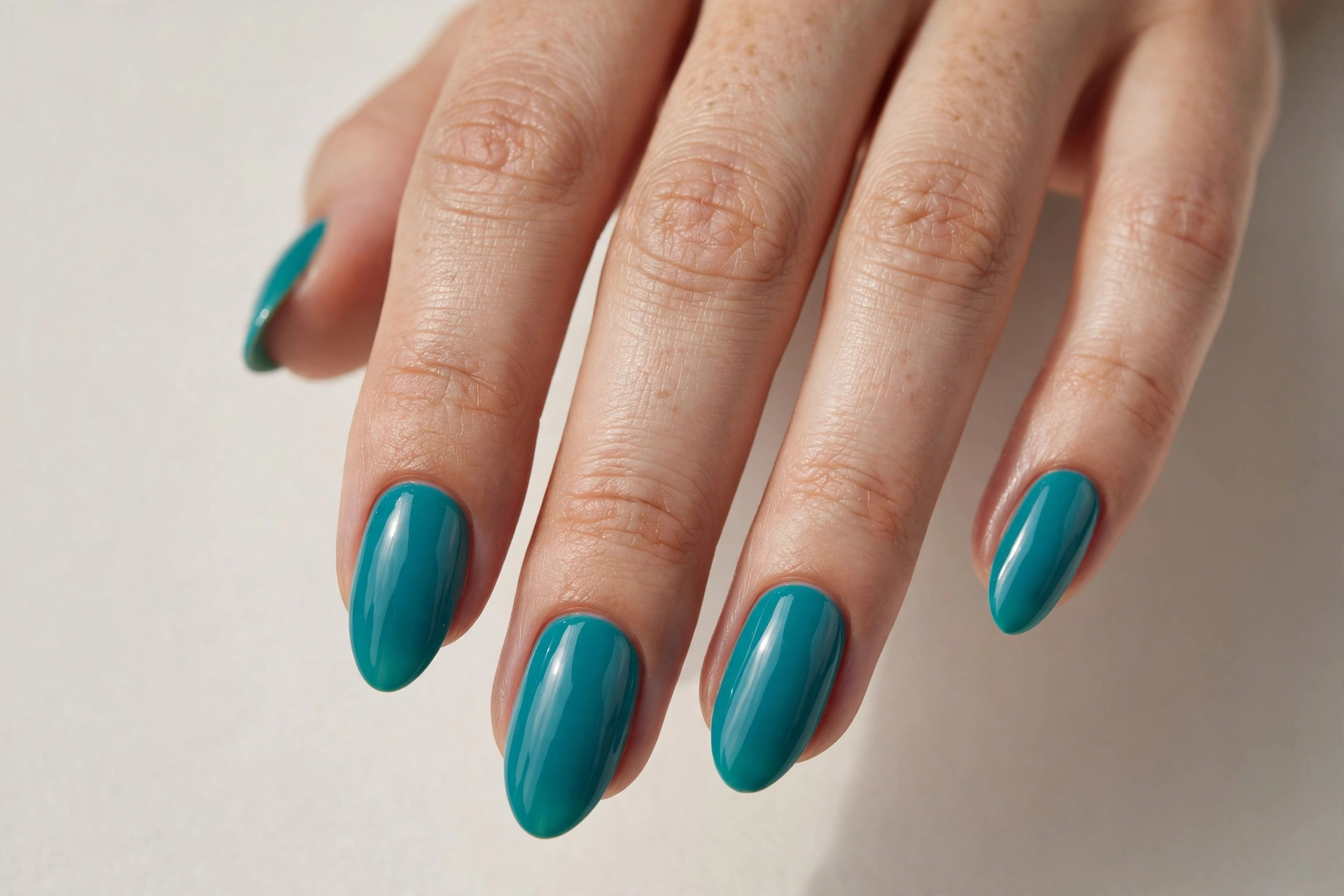 Teal turquoise nail varnish manicure on almond shaped nails