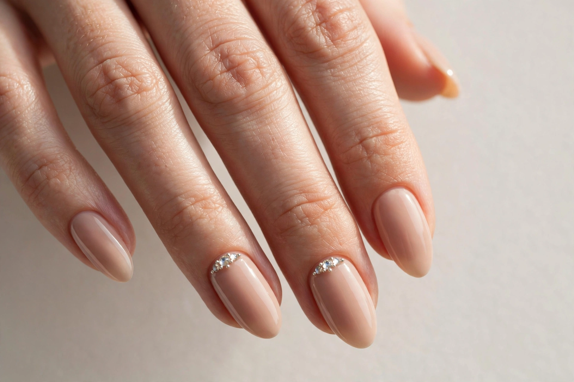 Nude nails with sparkling rhinestone crystal accents