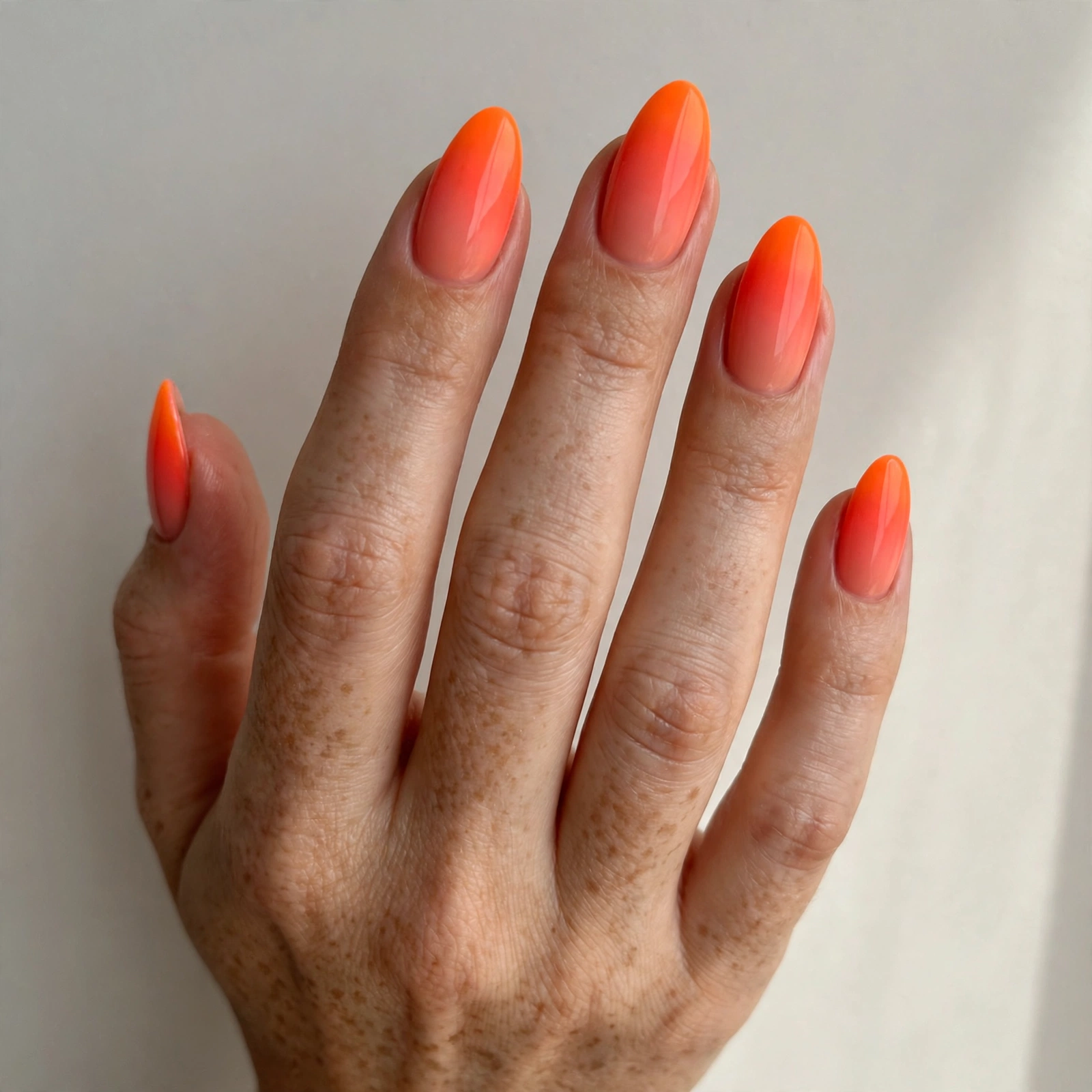 Neon orange sunset ombre nails blending into coral