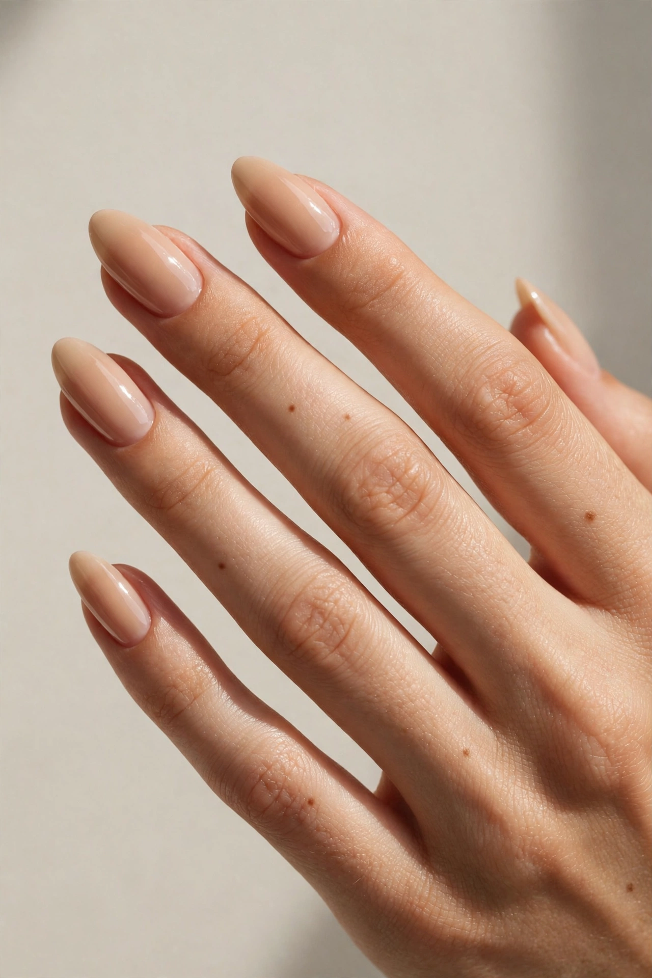 Warm almond bare nails with glossy clear top coat