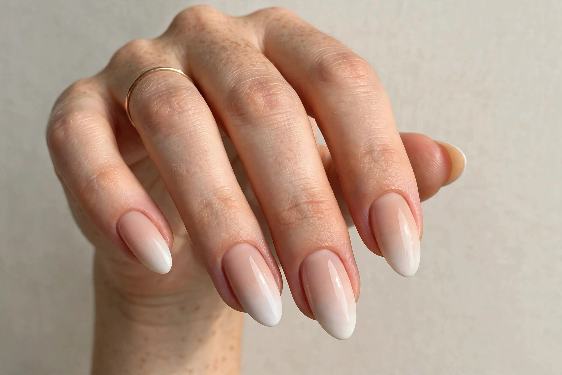 Nude ombre baby boomer fade manicure on almond nails