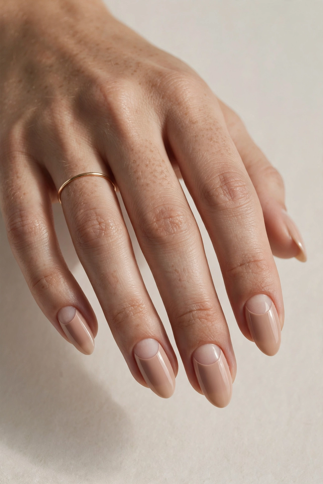Nude manicure with negative-space half moon details