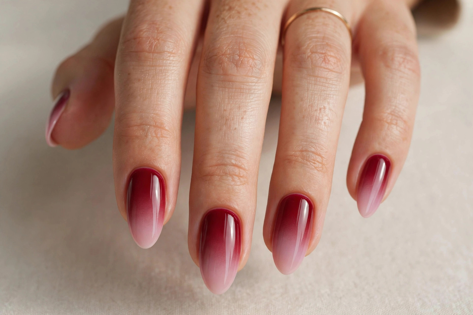Wine red ombre nails fading from deep red to soft pink