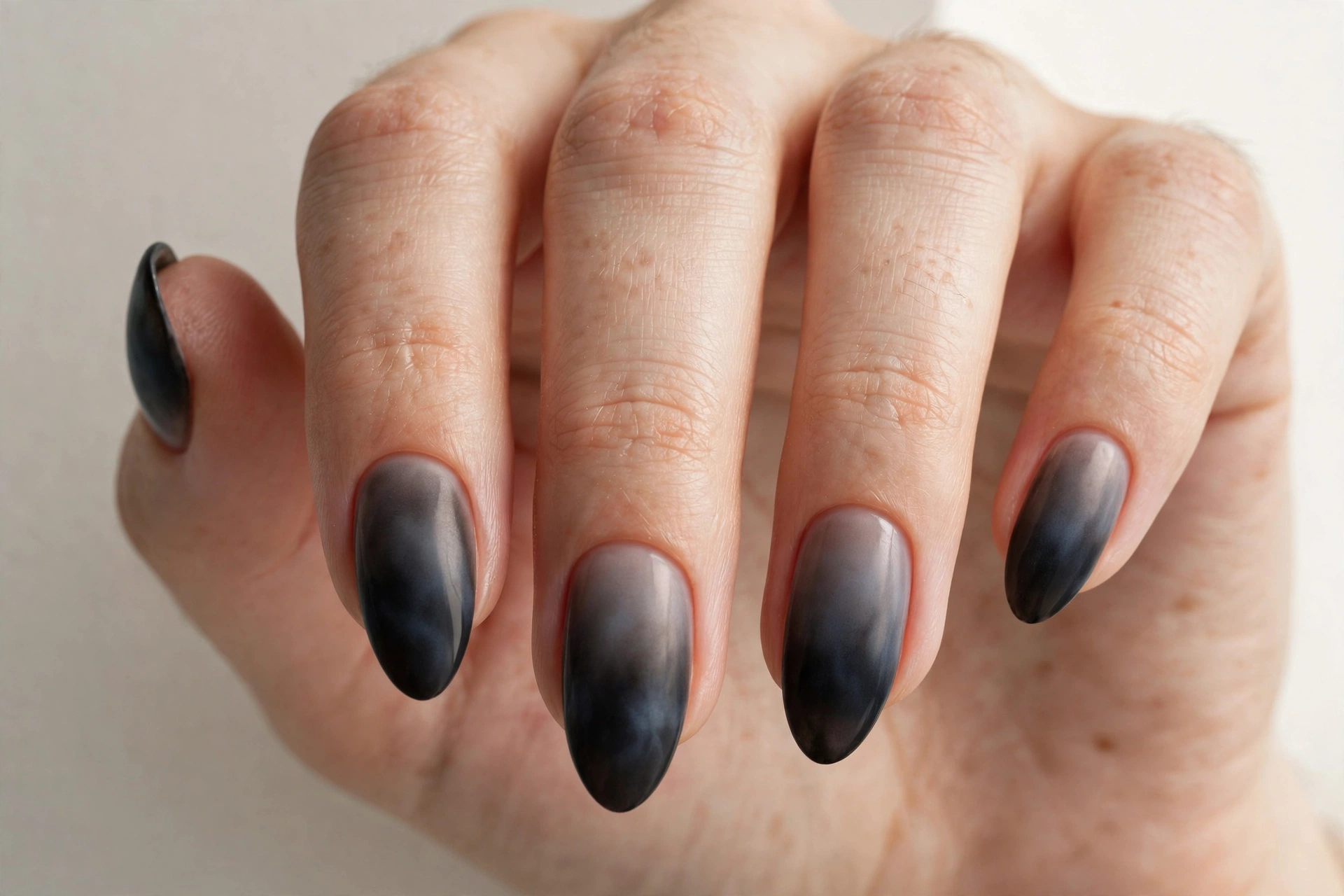 Black-to-grey smoky ombre manicure, edgy dark gradient nails