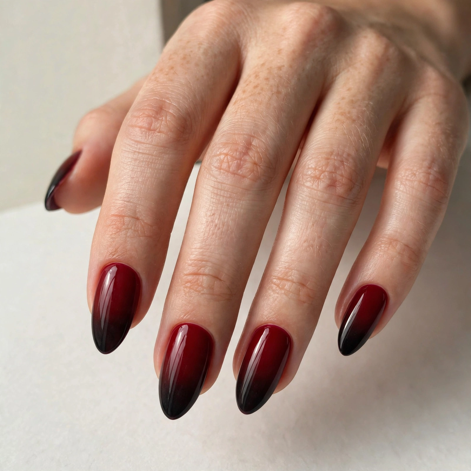 Deep red fading to black vamp ombre nails, bold dark gradient