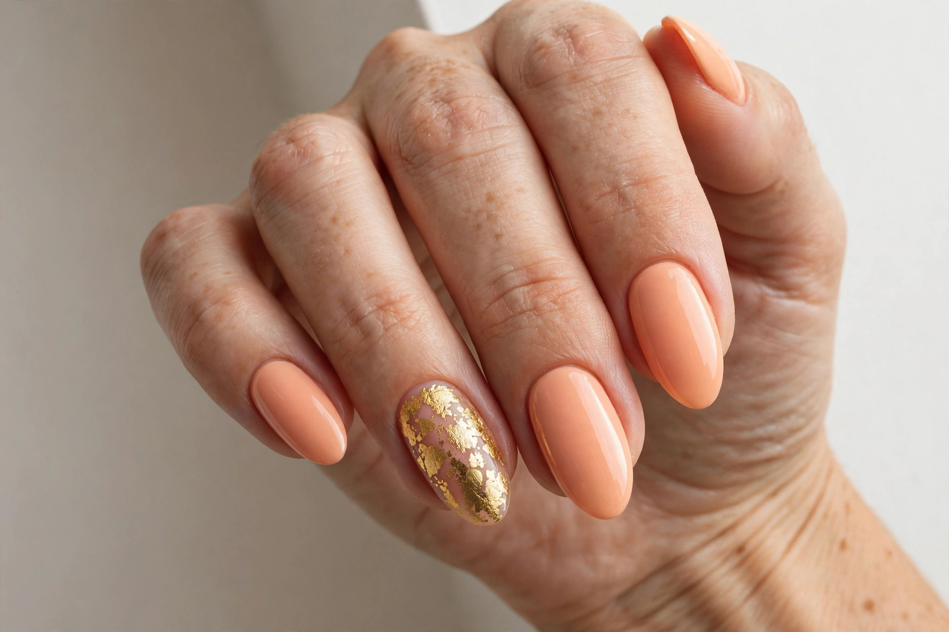 Peach sorbet pastel nails with gold foil accent nail