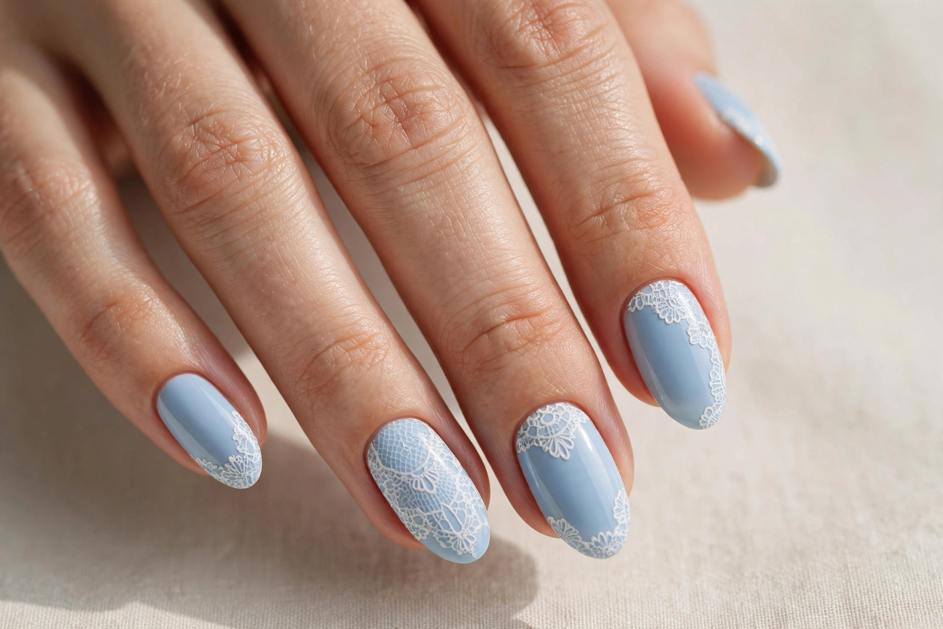 Baby blue pastel nails with delicate white lace pattern accents