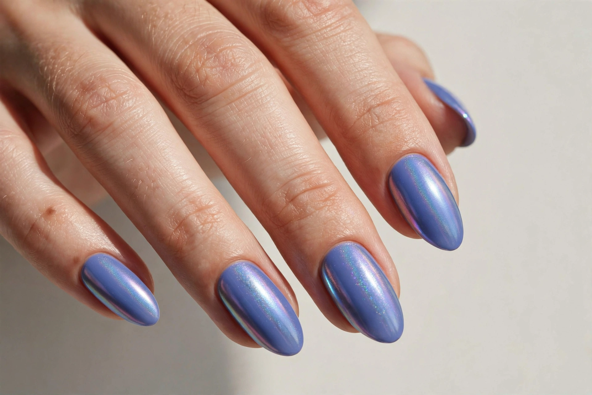 Periwinkle blue pastel nails with iridescent chrome shine