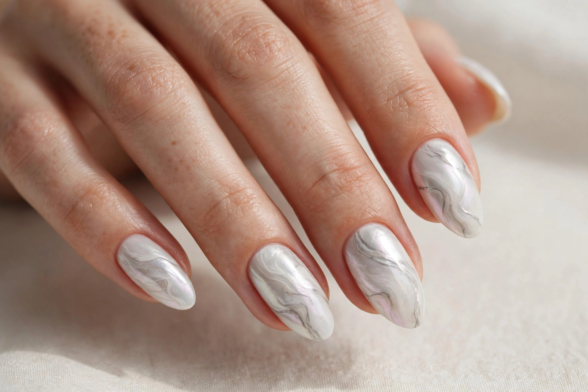 White pearl marble swirl manicure with elegant veins