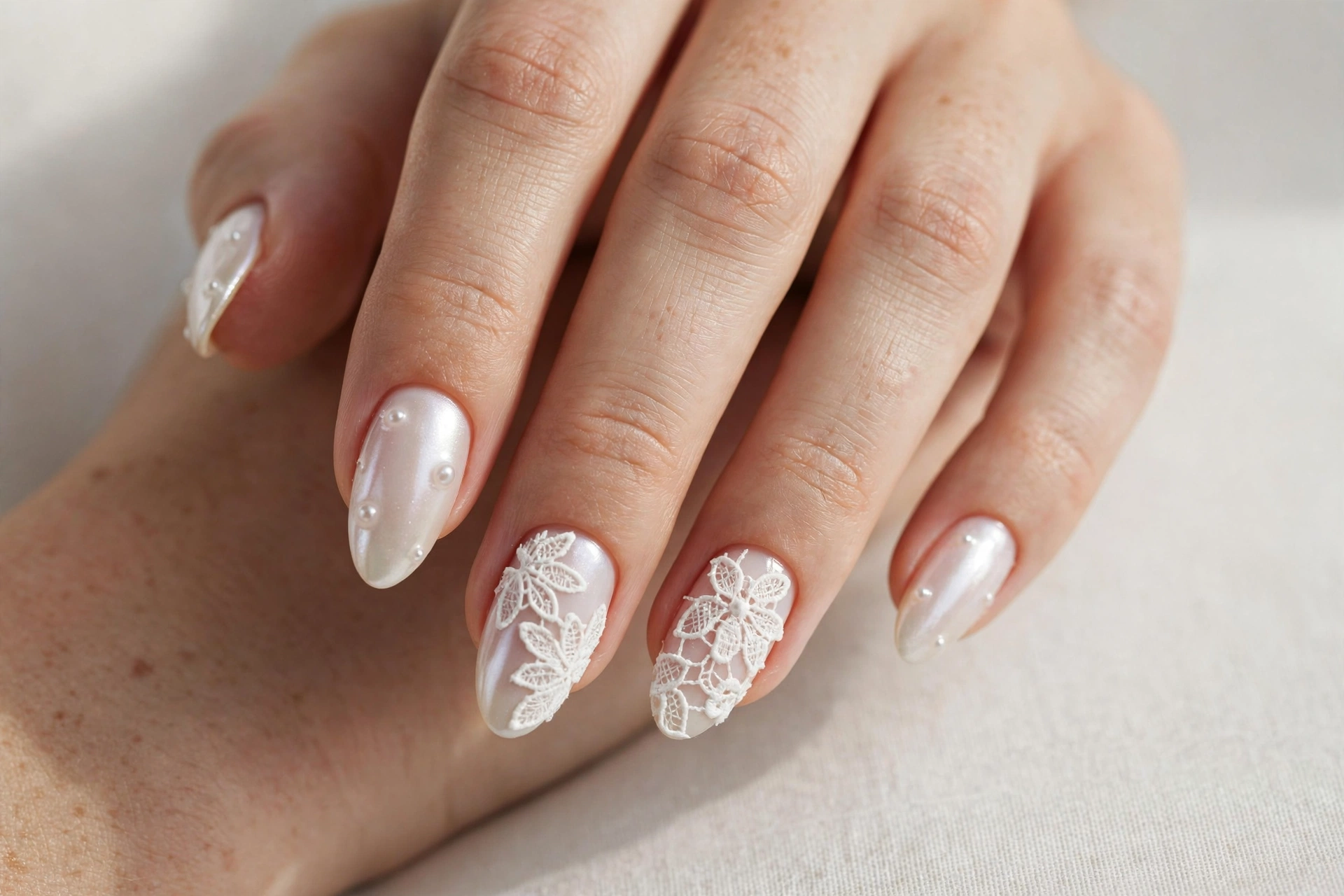 Pearl manicure with white lace applique art on accent nails