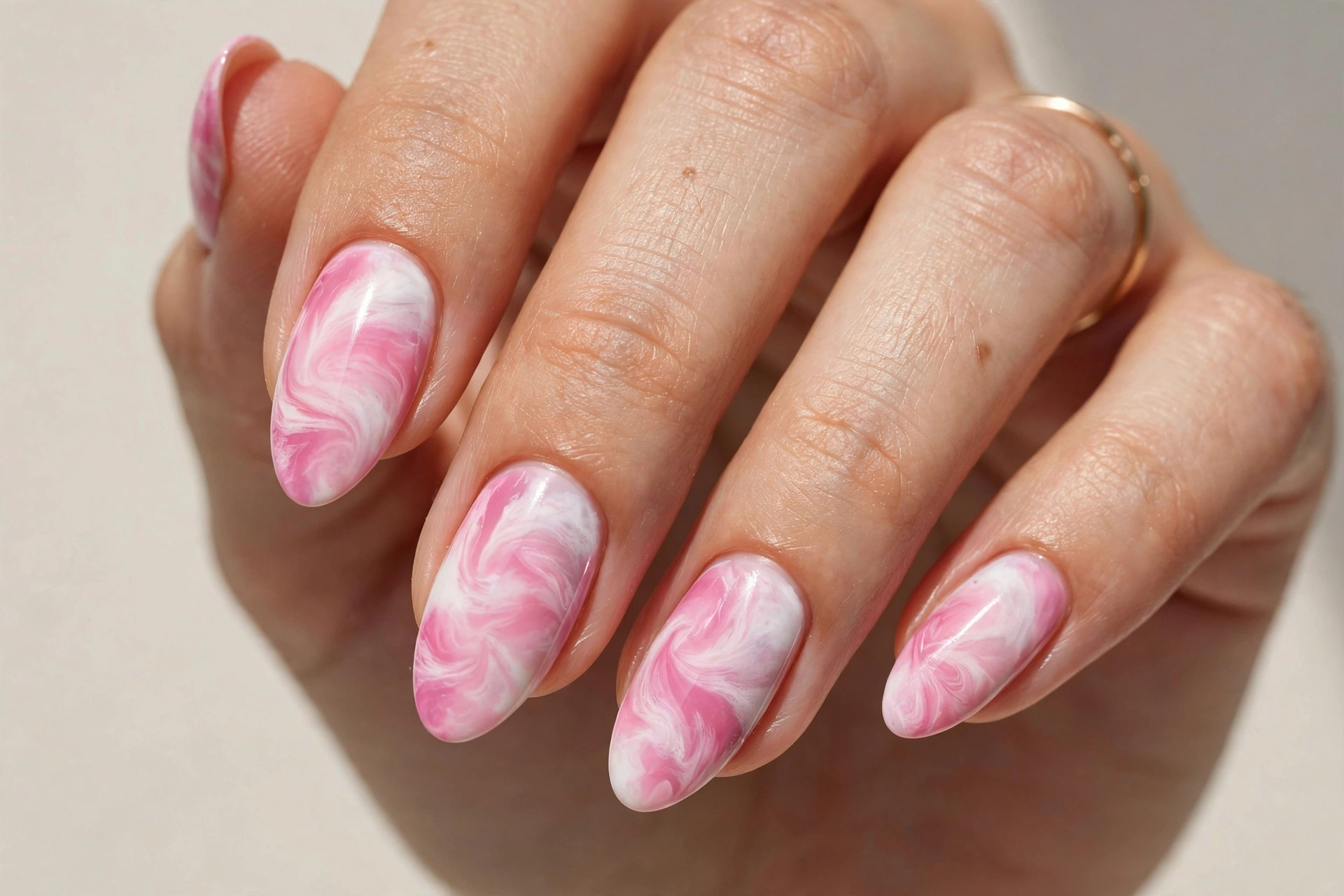Pink and white tie dye swirl nail design
