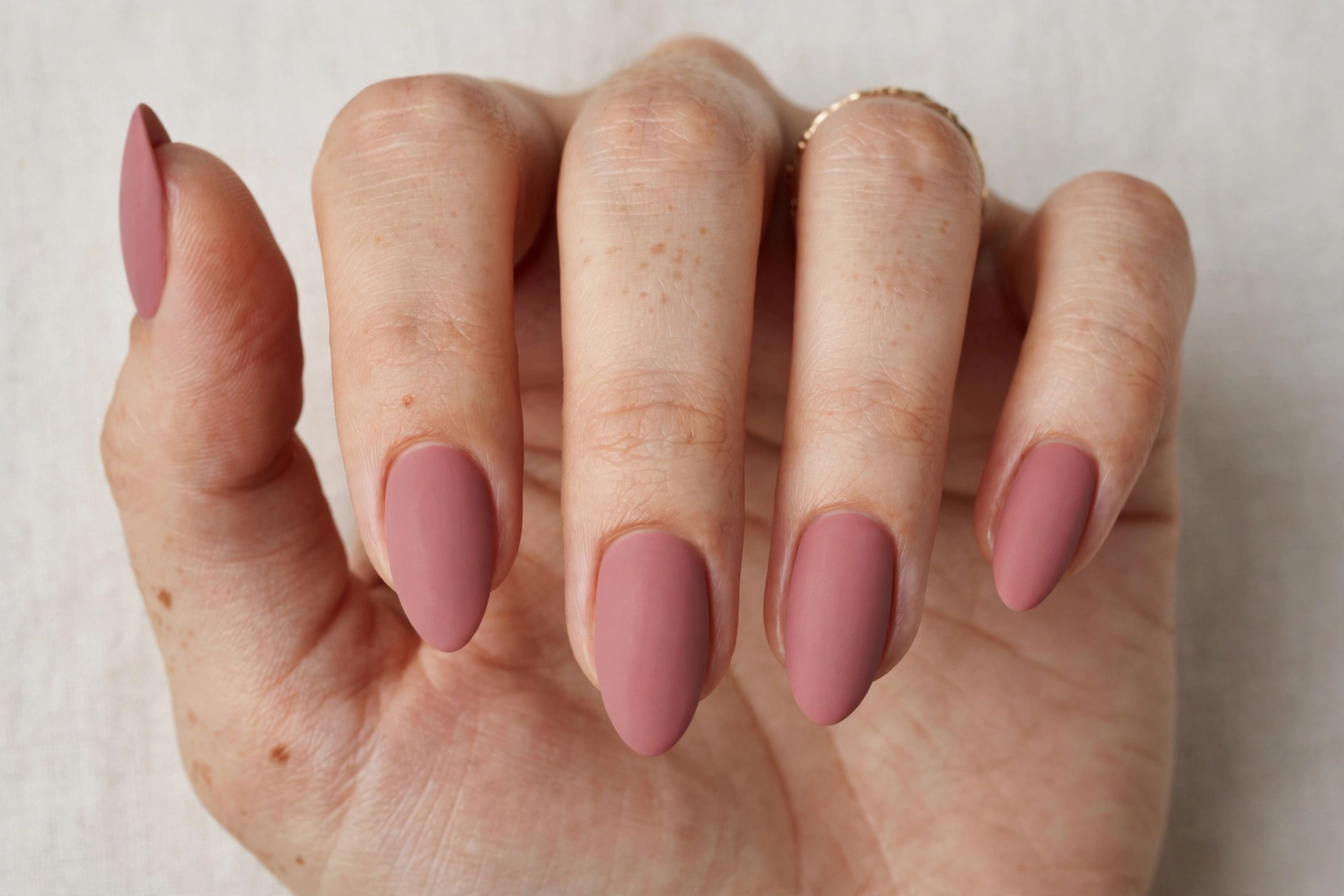 Close-up of a dusty rose matte manicure