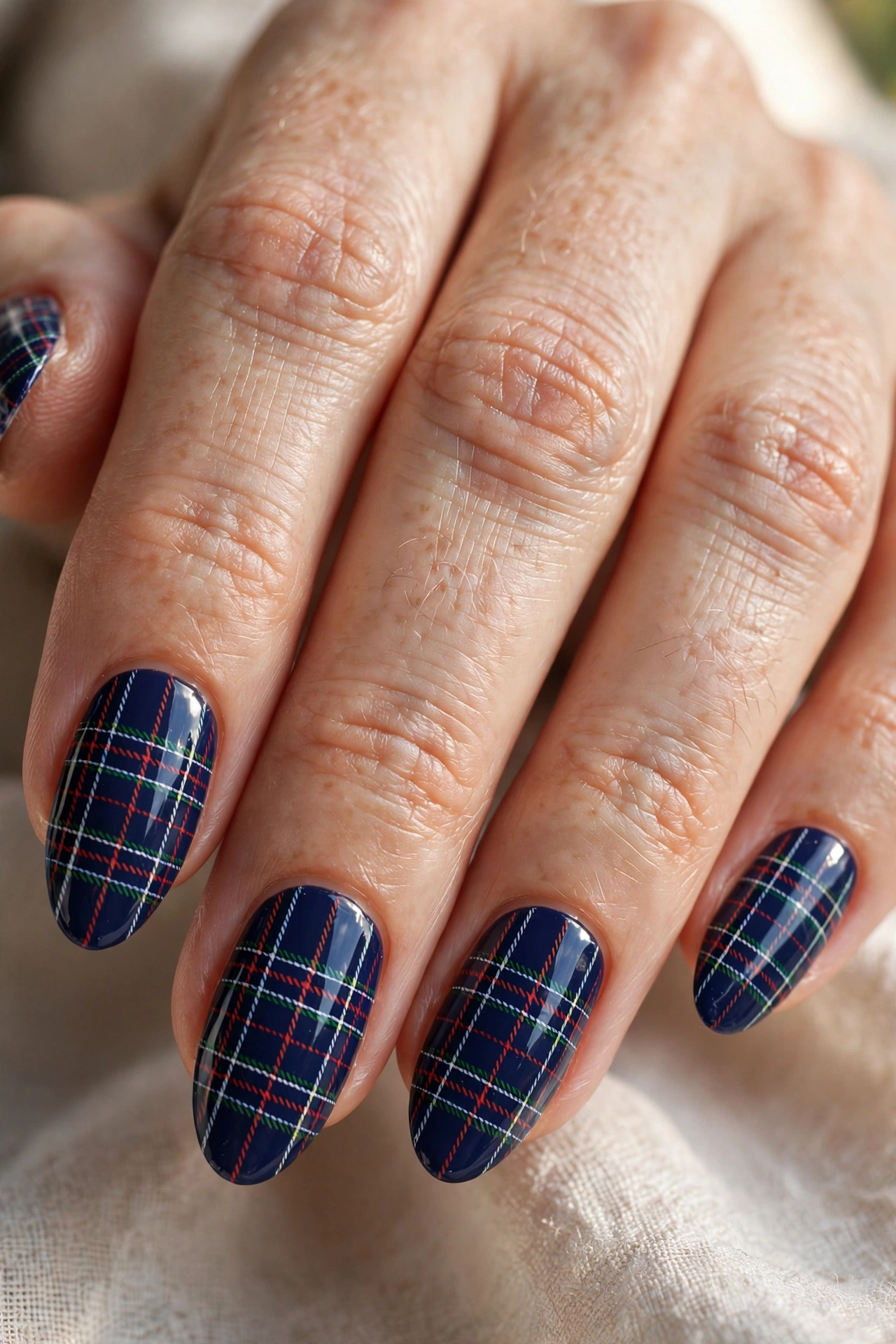Almond shaped nails with navy blue preppy plaid nail art