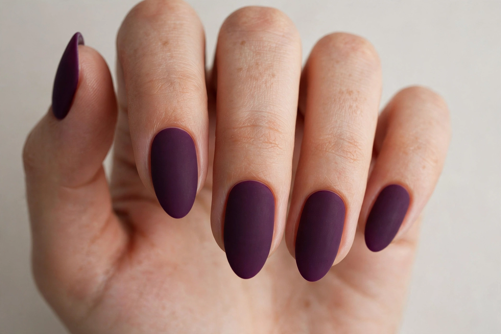 Matte deep plum manicure with velvety non-shiny finish