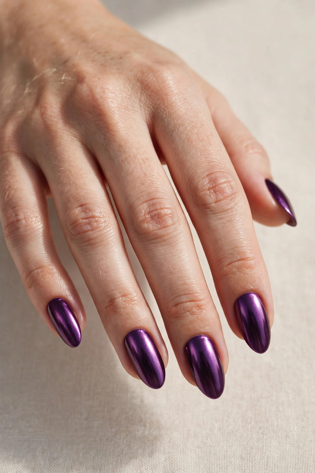 Plum purple chrome manicure with mirror-like metallic finish
