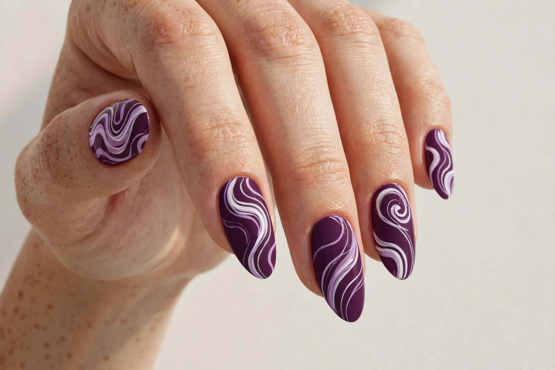 Plum nails with abstract wavy swirl line art in lilac and white