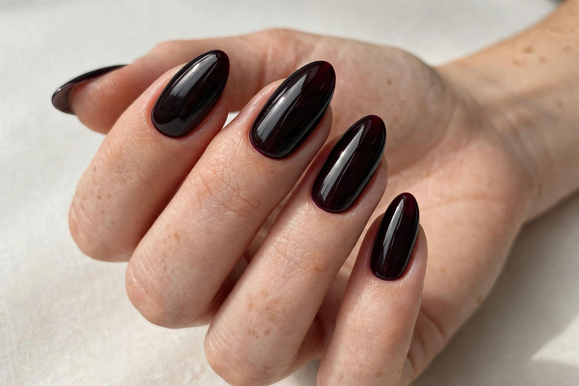 Black-cherry dark plum almost-black glossy manicure
