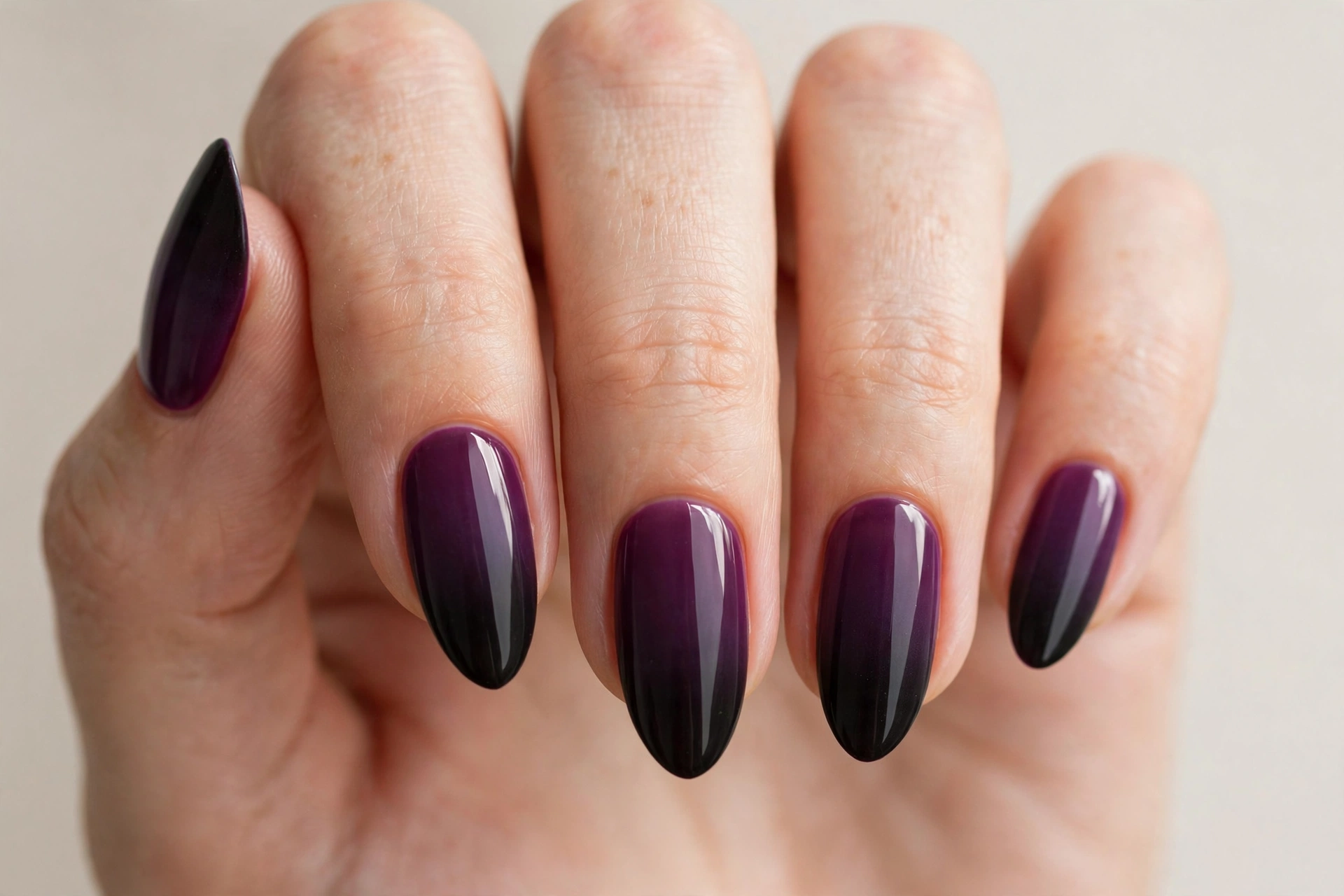 Vertical gradient manicure fading from wine plum purple to black