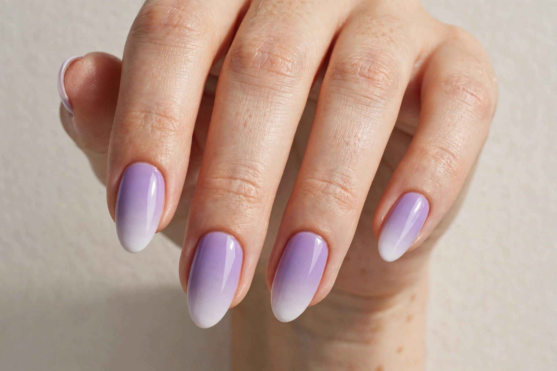 Almond nails with lavender purple ombre manicure fading to white tips