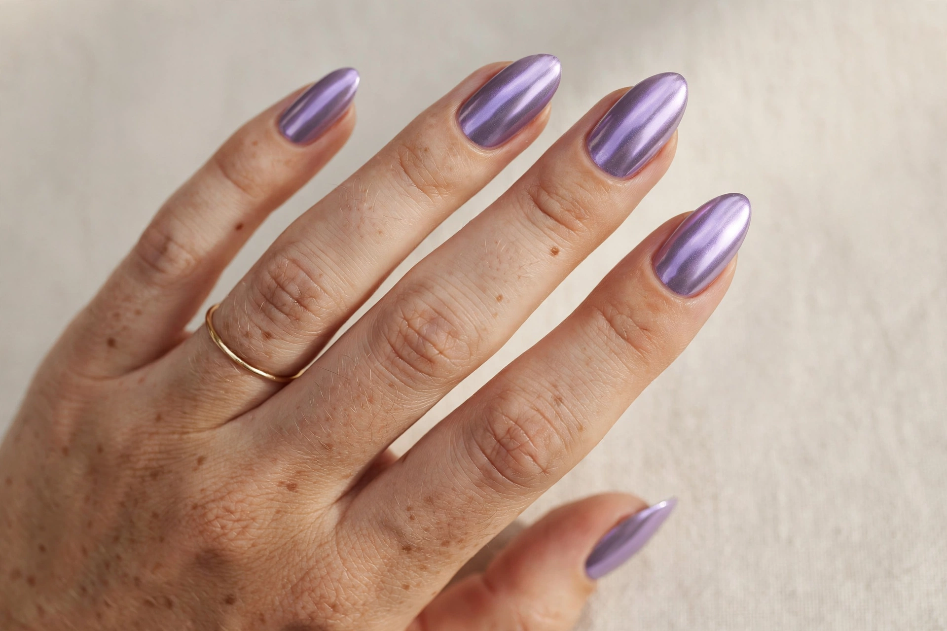 Lavender chrome mirror manicure on almond-shaped nails