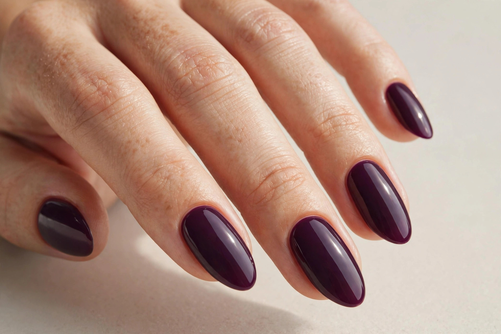 Deep plum glossy purple manicure