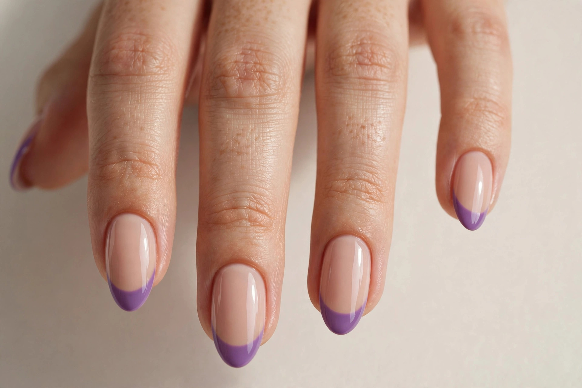 Purple French tip manicure on nude base