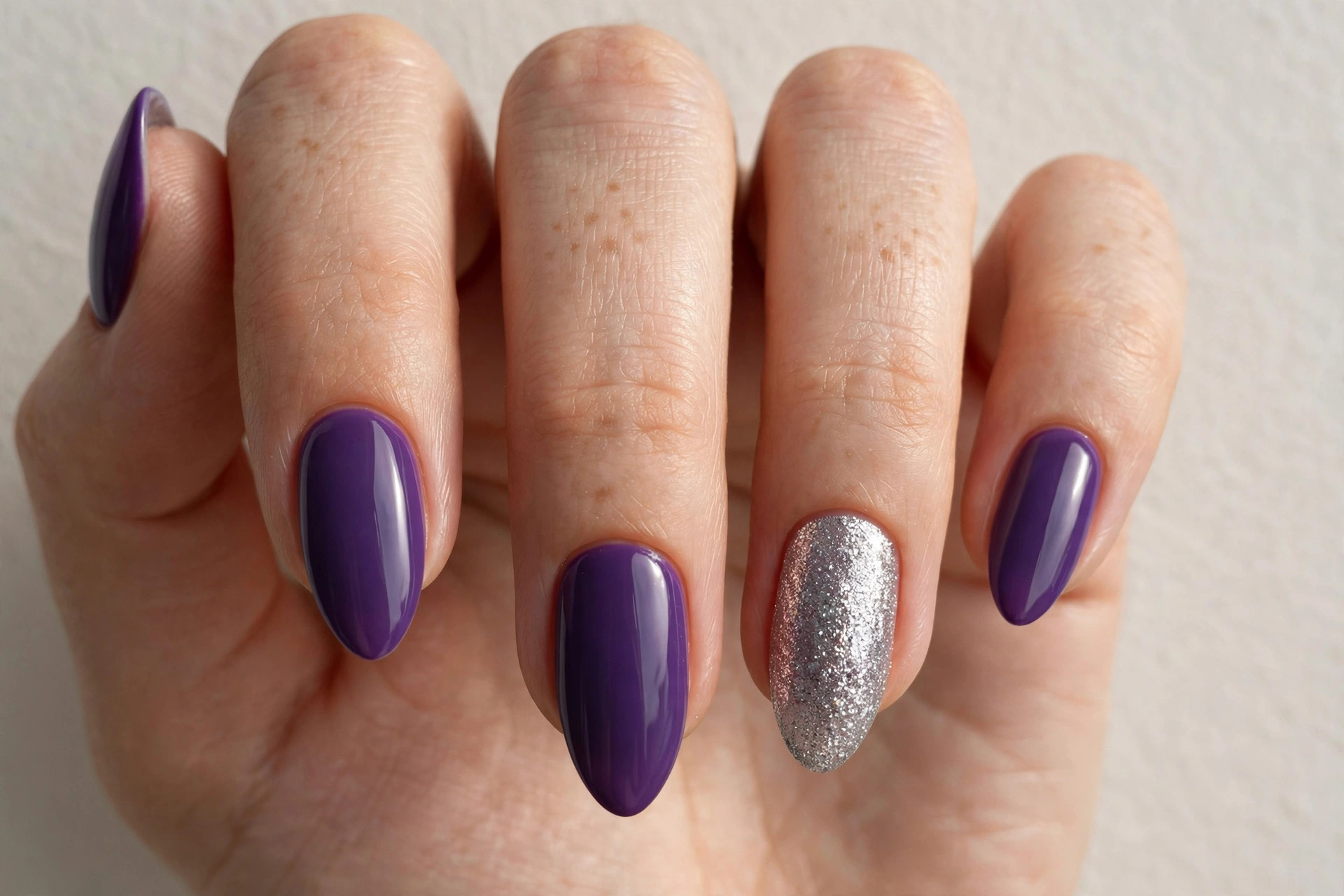 Purple manicure with silver glitter accent nails
