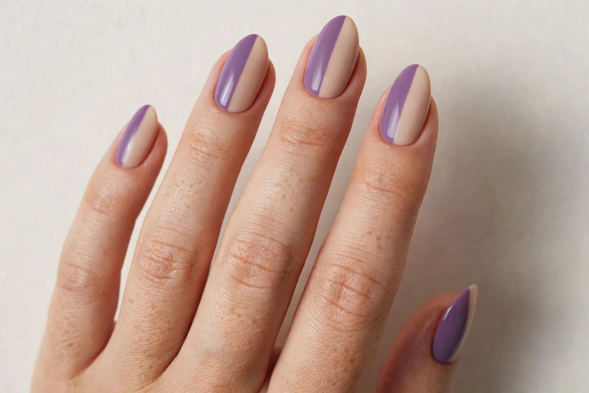 Two-tone purple and nude half nail art manicure