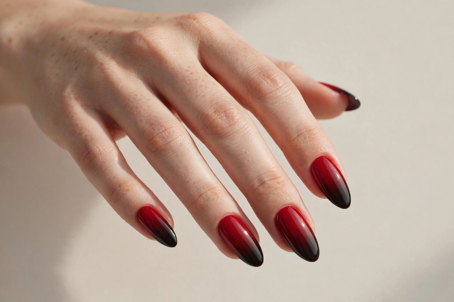 Red to black ombre fade nail design on almond shaped nails