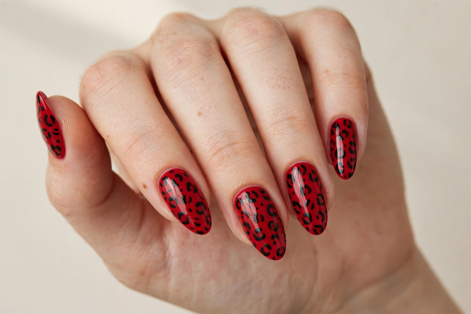 Red nails with black leopard animal print