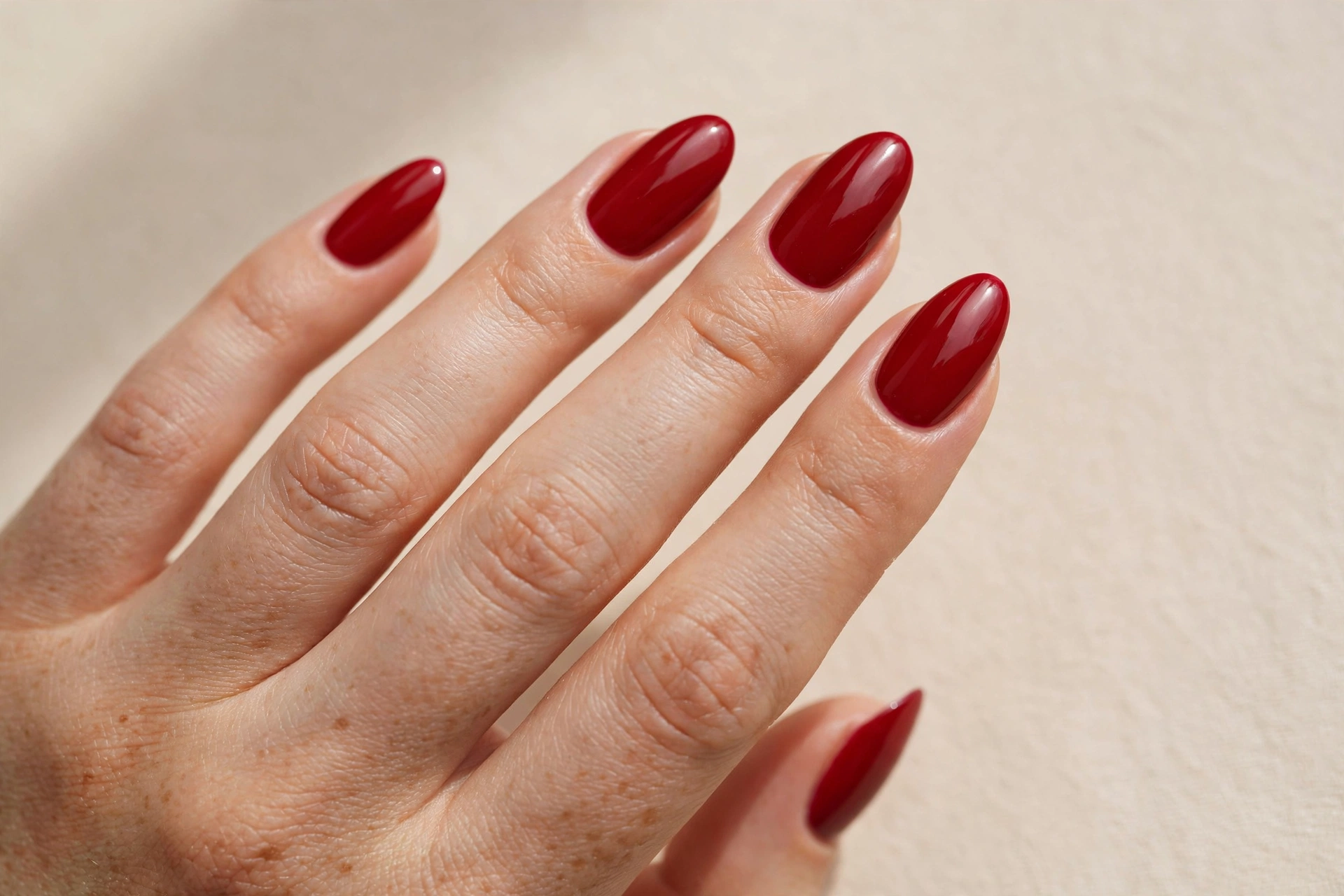 Classic glossy cherry red almond manicure