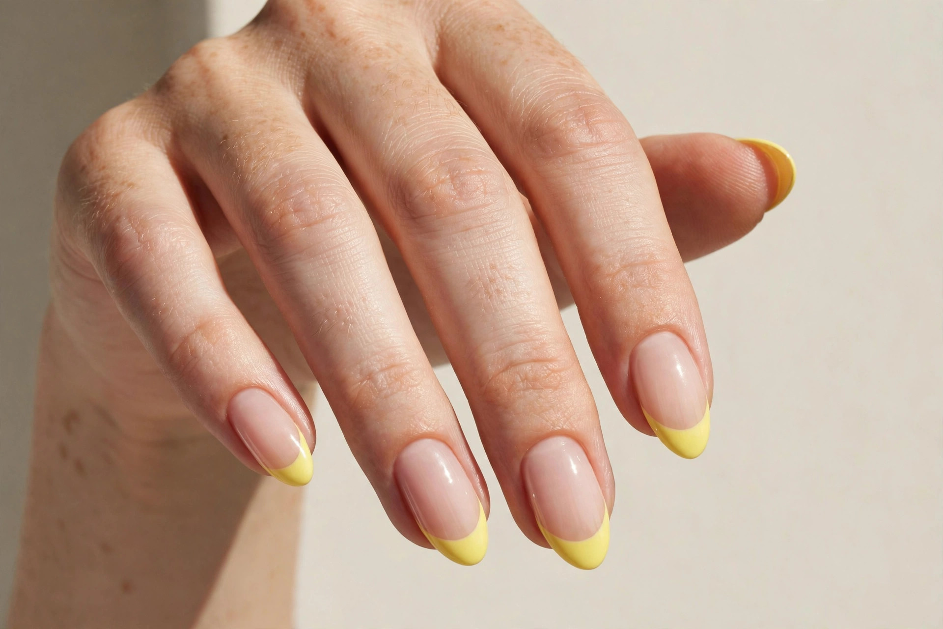 Lemon yellow french tip manicure on nude almond nails