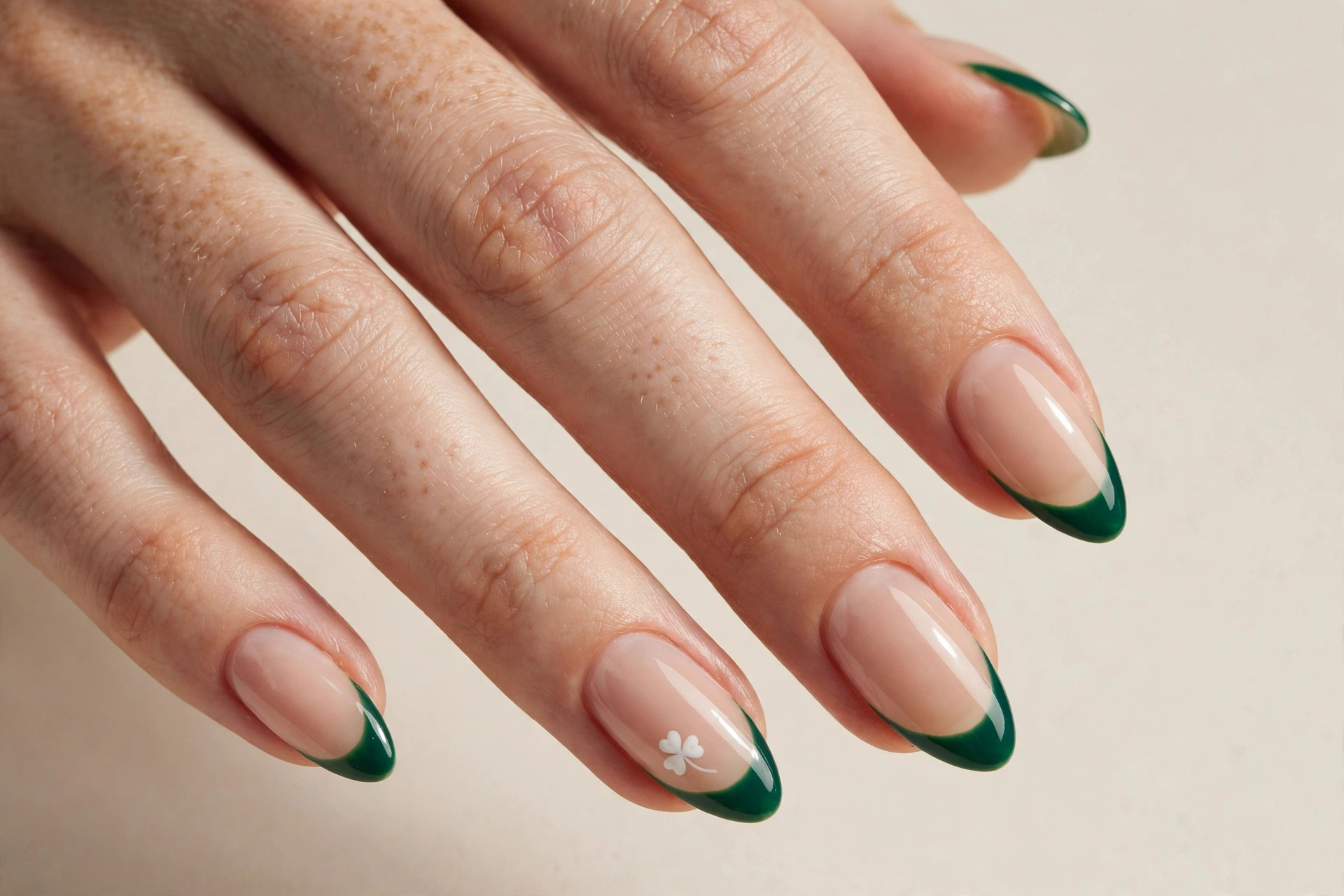 Nude nails with emerald clover French tips
