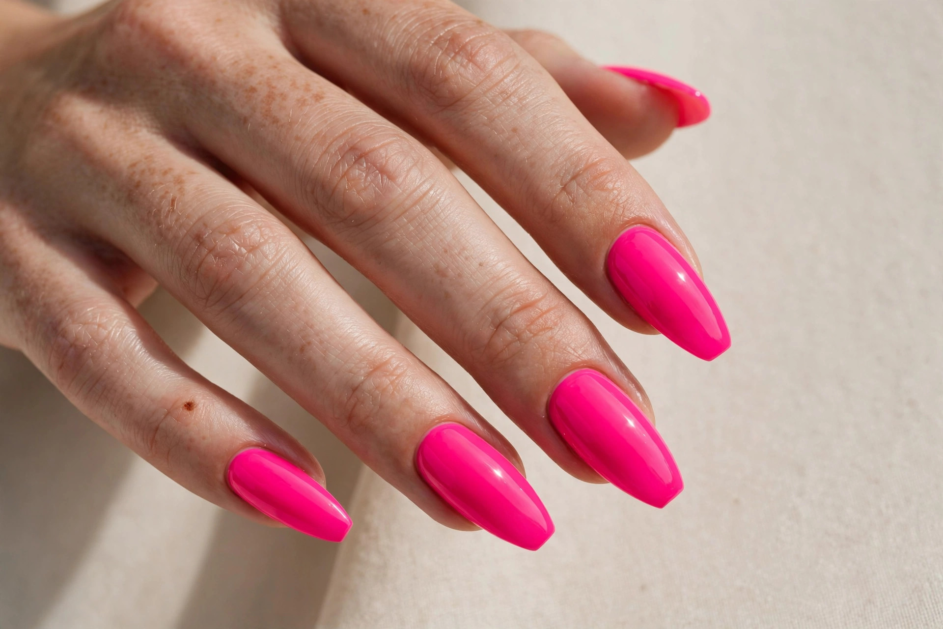 Neon pink manicure on almond nails