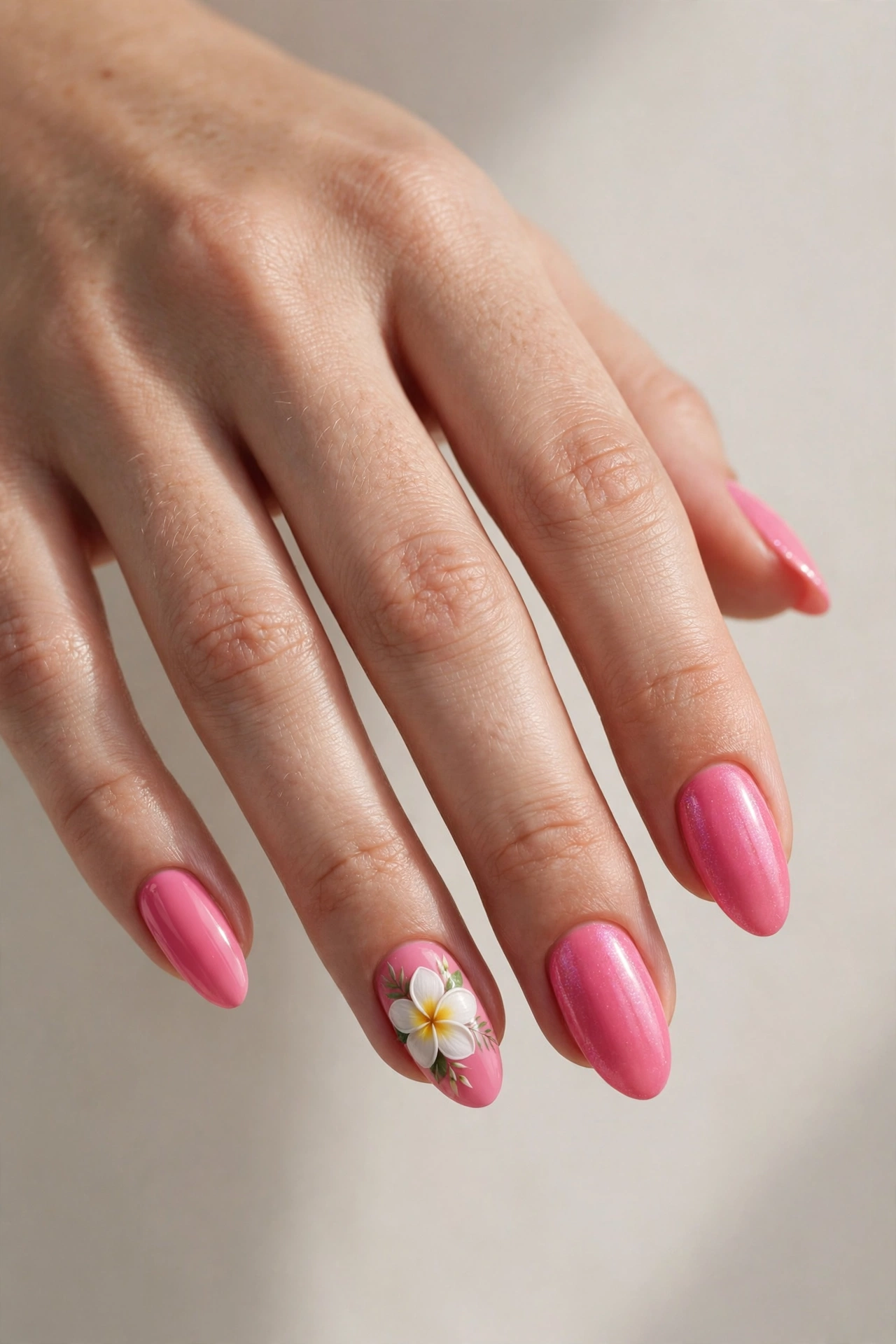 Flamingo pink nails with white tropical flower accent